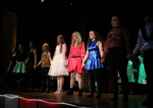 Stage Performance - A group of young performers taking a bow at the end of a show