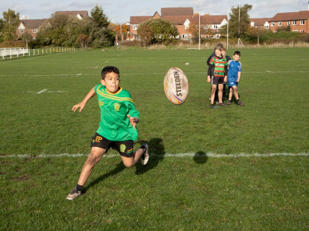 Kid catching a Rugby ball