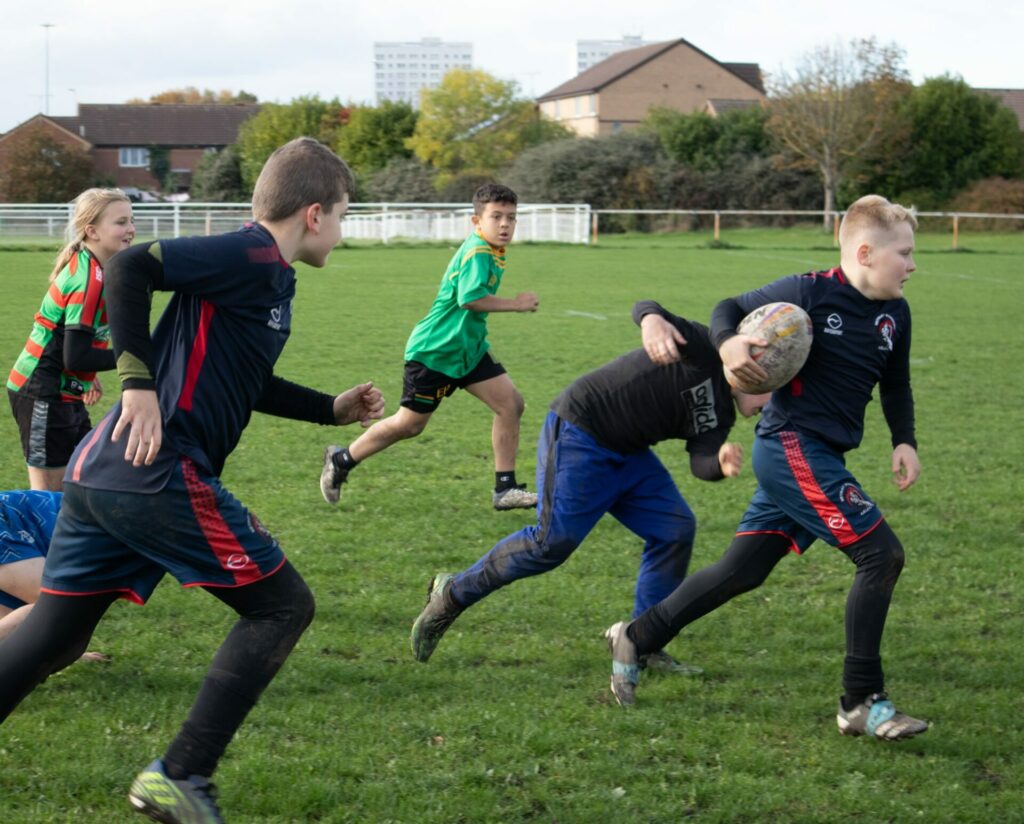 Kids playing Rugby on the field