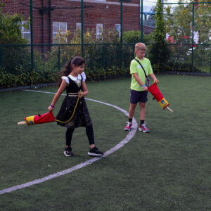 Two young people learning how to throw safety rope into water to help save someone