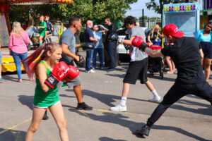 Two people sparring outside at The Hunslet Club - showcases their skills to the crowd.